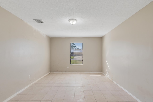 unfurnished room with a textured ceiling