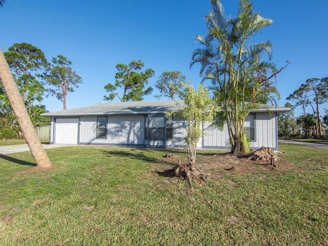 view of front of property featuring a garage and a front lawn