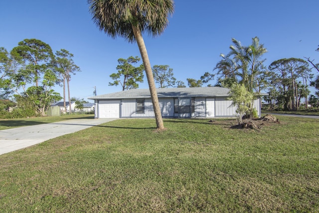 ranch-style home featuring a garage and a front lawn