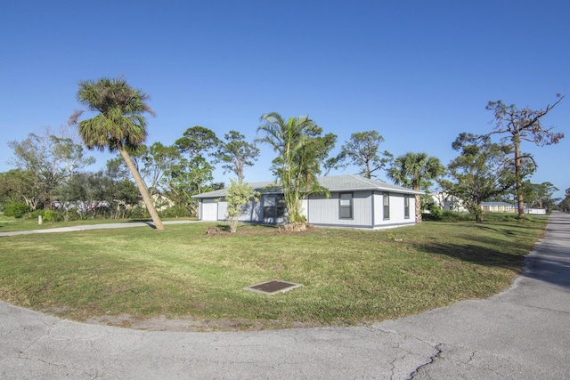 single story home with a garage and a front yard