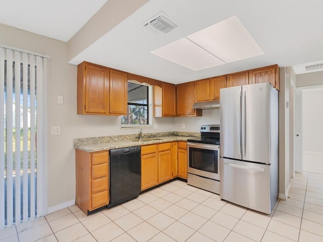 kitchen with stainless steel appliances, sink, and light tile patterned floors