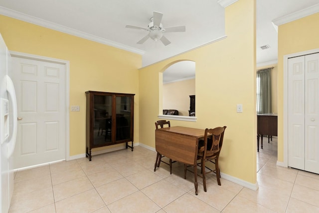 dining area featuring crown molding, ceiling fan, and light tile patterned floors