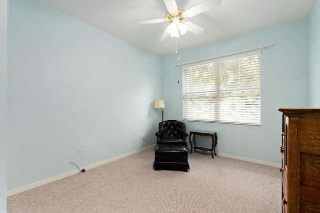 living area with ceiling fan and light colored carpet