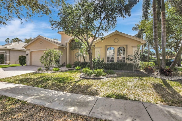 view of front of property with a garage and a front lawn