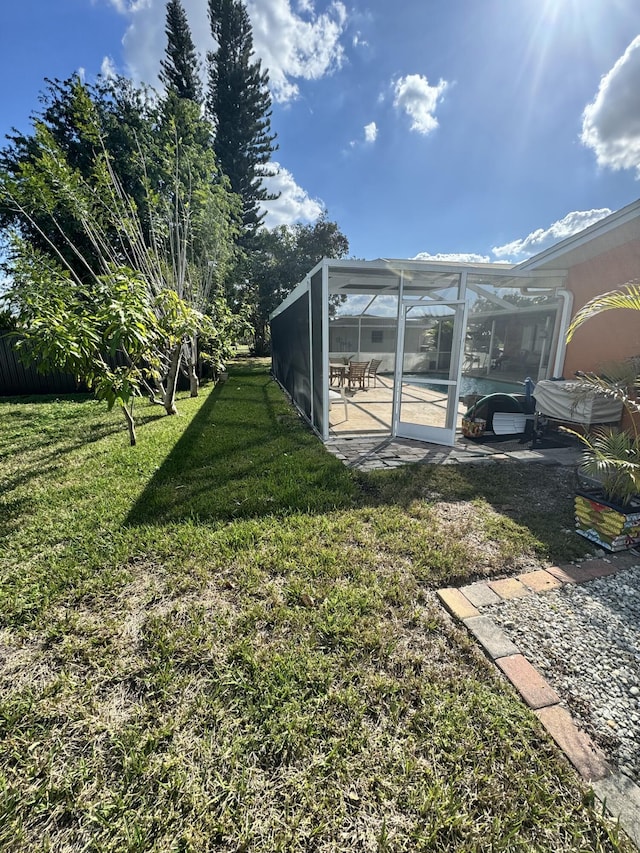 view of yard with a lanai and a patio area