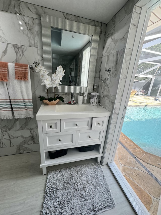 bathroom with tile walls and vanity