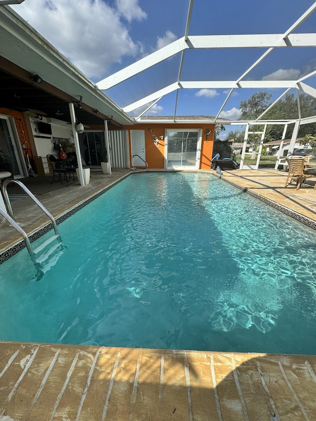 view of pool with a lanai and a patio