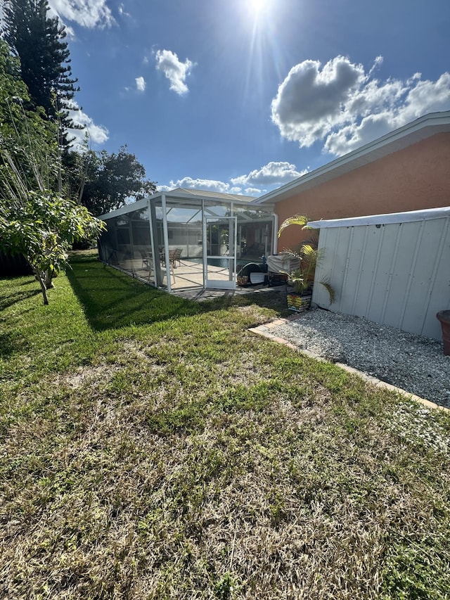 view of yard with a lanai and a patio area