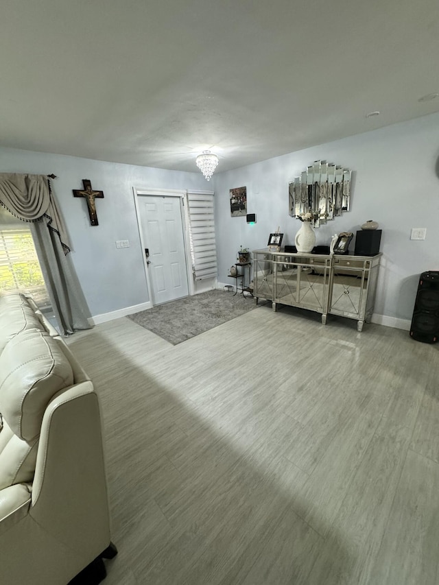 living room featuring hardwood / wood-style floors and a notable chandelier