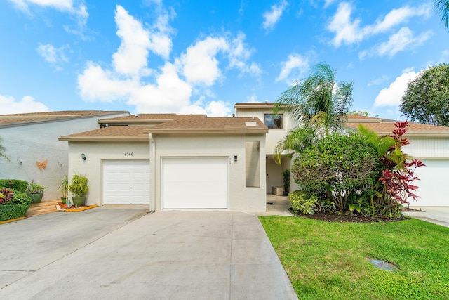 view of front of home with a garage and a front lawn