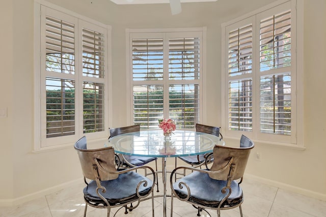 tiled dining space with ceiling fan