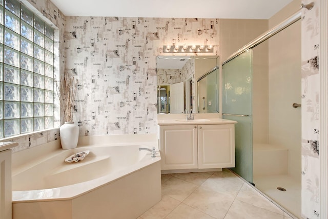 bathroom featuring vanity, a wealth of natural light, tile patterned floors, and independent shower and bath