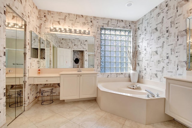 bathroom with vanity, tile patterned floors, and a bathing tub