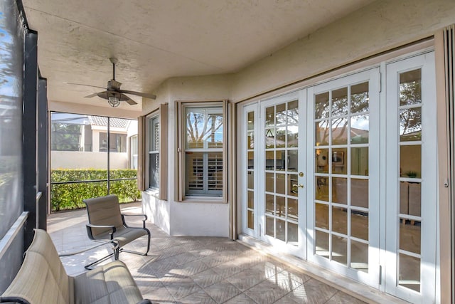 unfurnished sunroom with french doors and ceiling fan