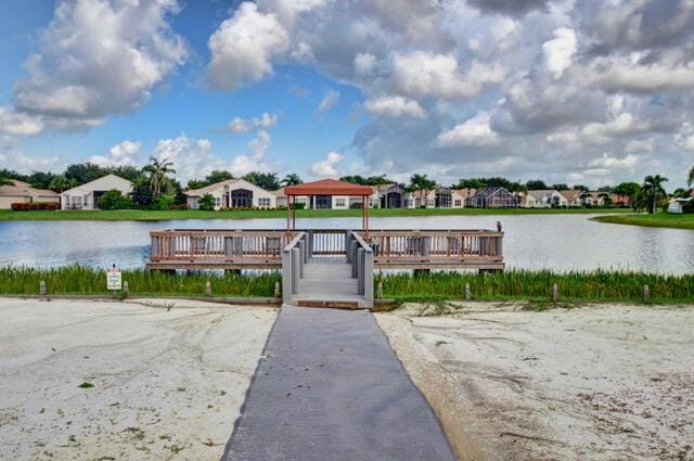 view of dock with a gazebo and a water view