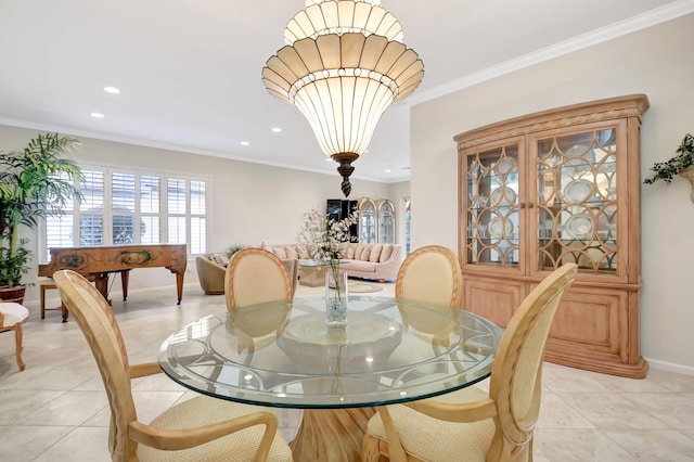 dining space with light tile patterned flooring, ornamental molding, and a notable chandelier