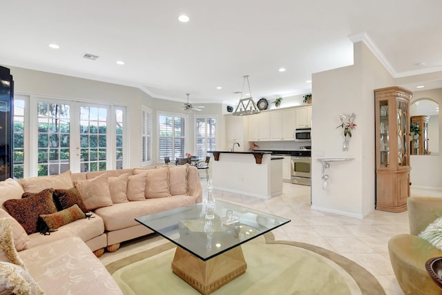 tiled living room featuring crown molding, ceiling fan, and french doors