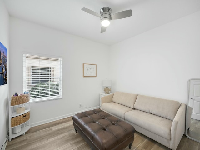 living room with ceiling fan and light hardwood / wood-style flooring