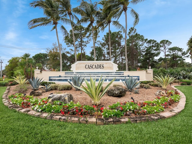 community sign featuring a lawn