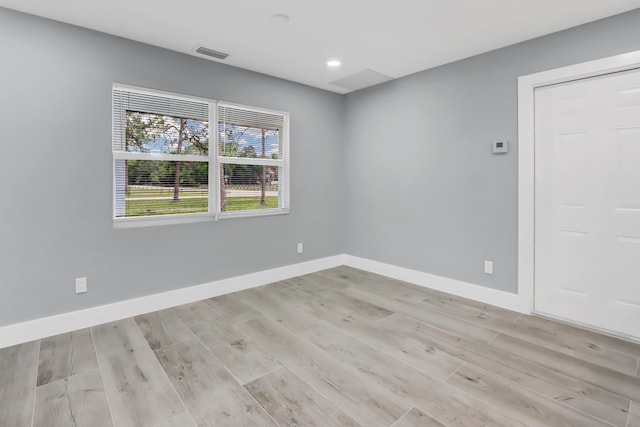 unfurnished room featuring light hardwood / wood-style floors