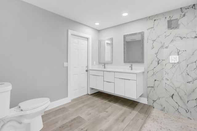 bathroom with walk in shower, vanity, toilet, and hardwood / wood-style flooring