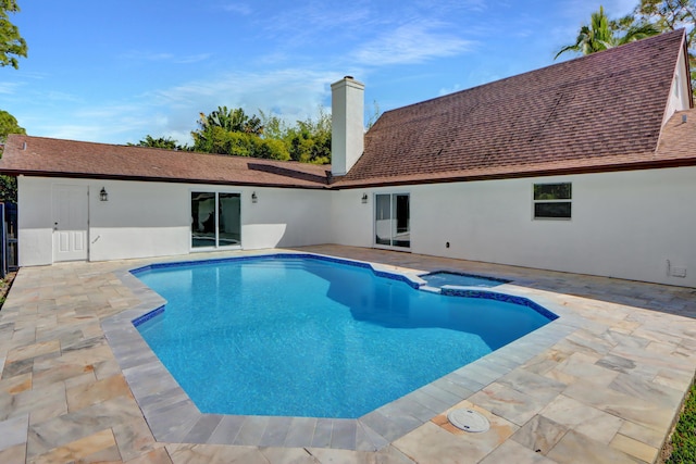 view of pool featuring an in ground hot tub and a patio