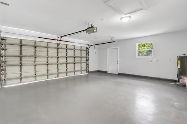 garage featuring a garage door opener and water heater