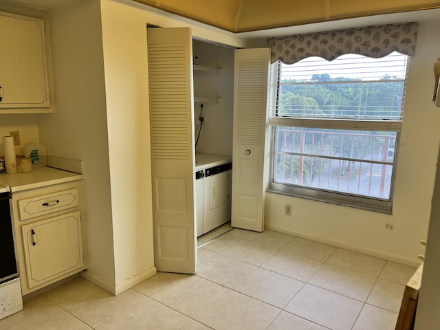 laundry area with washer / clothes dryer and light tile patterned flooring