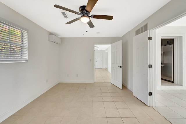 tiled empty room with an AC wall unit and ceiling fan