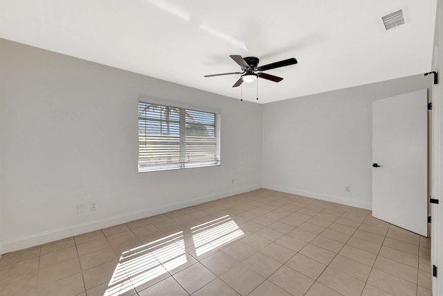 empty room featuring light tile patterned flooring and ceiling fan