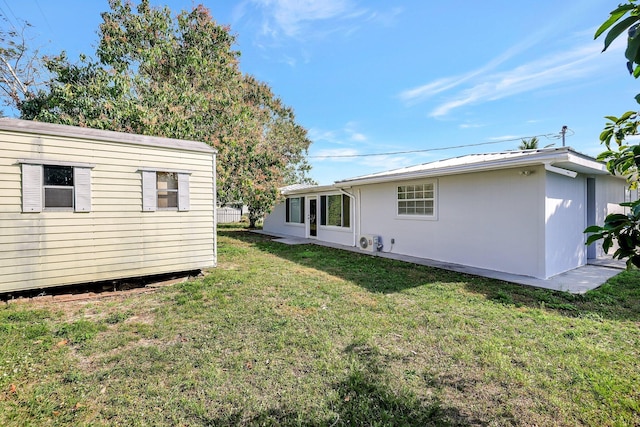 rear view of property featuring a yard