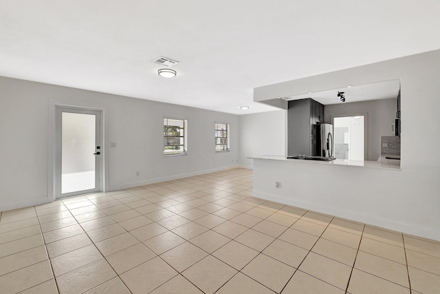 unfurnished living room featuring light tile patterned floors