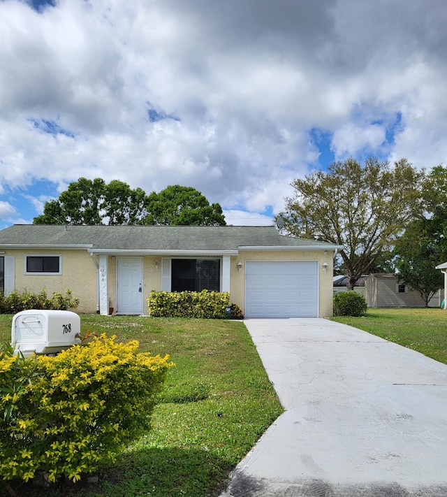 single story home featuring a garage, driveway, a front yard, and stucco siding