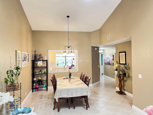 7895 La Mirada Dr, Boca Raton, FL 33433 - dining room featuring light tile patterned flooring, a chandelier, a high ceiling, and baseboards