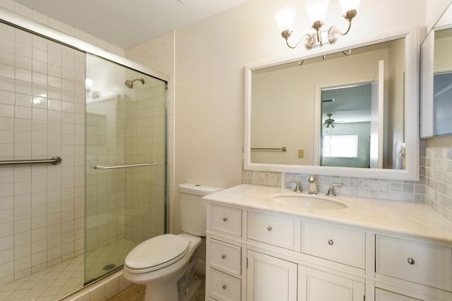 bathroom with toilet, tasteful backsplash, vanity, and a shower stall