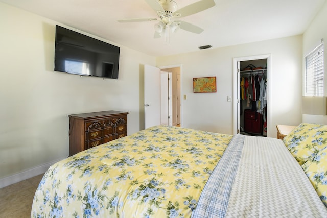 bedroom with ceiling fan, visible vents, baseboards, a spacious closet, and a closet