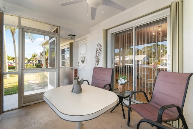 sunroom / solarium featuring a ceiling fan