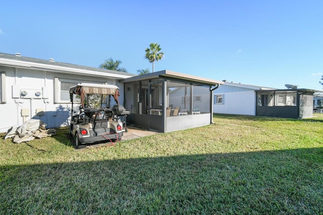 back of house featuring a sunroom and a yard