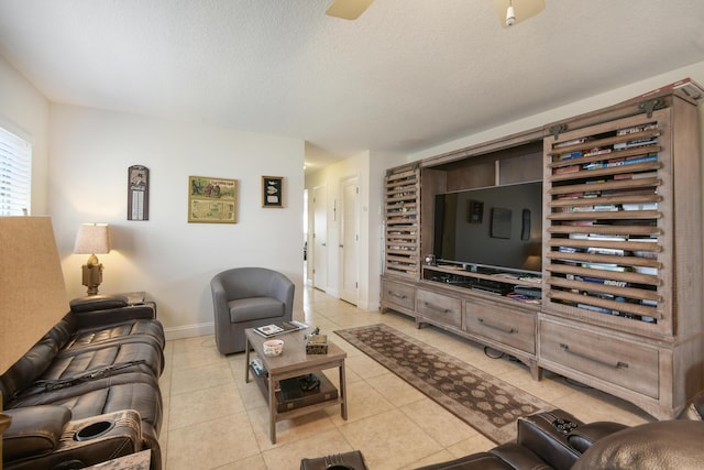 living room with light tile patterned floors, a textured ceiling, and baseboards