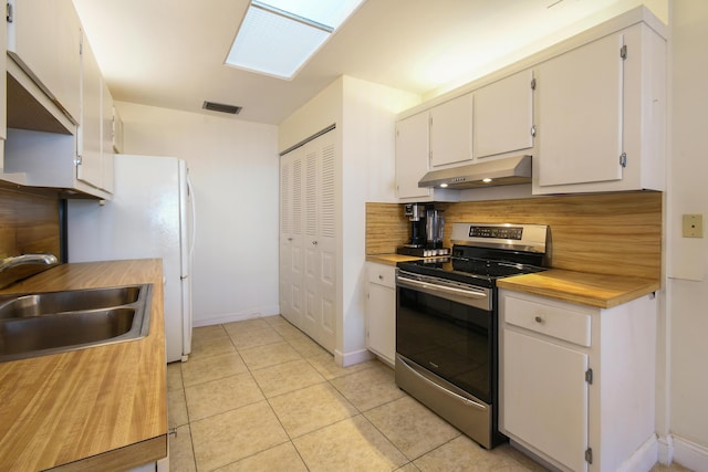 kitchen with under cabinet range hood, white cabinetry, a sink, and electric range