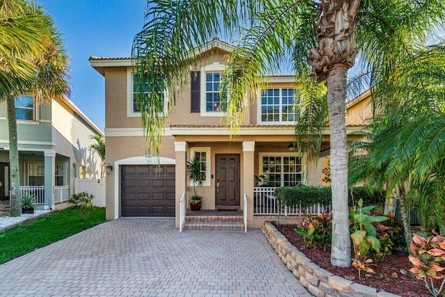 view of front of house featuring a garage and covered porch