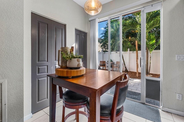 dining space featuring light tile patterned floors