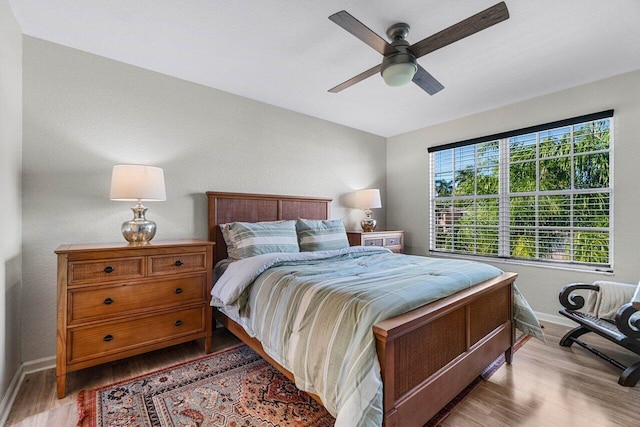 bedroom with hardwood / wood-style flooring and ceiling fan