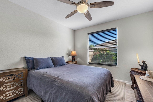 bedroom with ceiling fan and light wood-type flooring