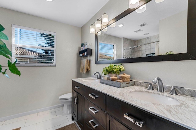 bathroom with walk in shower, plenty of natural light, toilet, and vanity