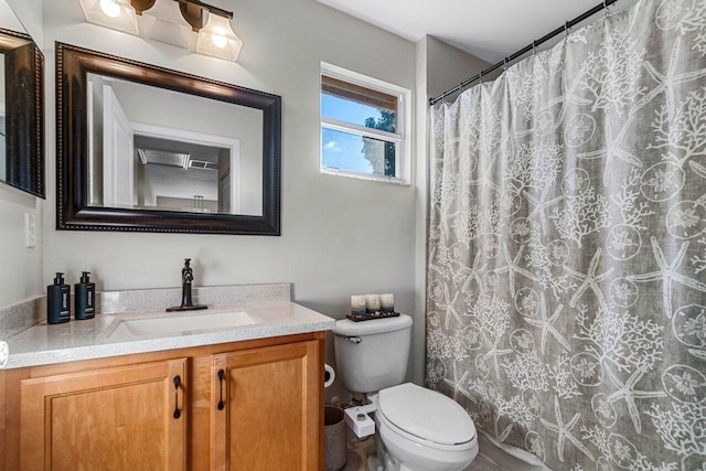 bathroom featuring vanity, curtained shower, and toilet