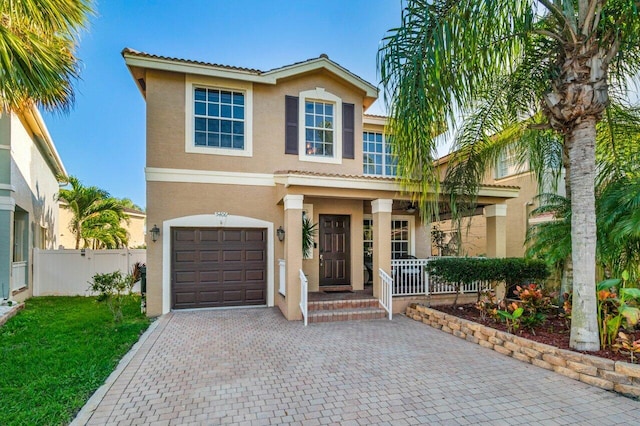 mediterranean / spanish-style home featuring a garage and a porch