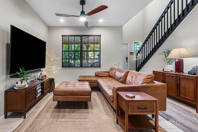 tiled living room with ceiling fan