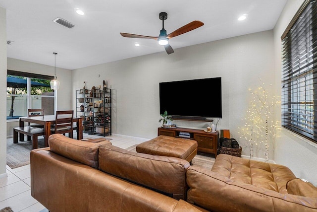 tiled living room with ceiling fan