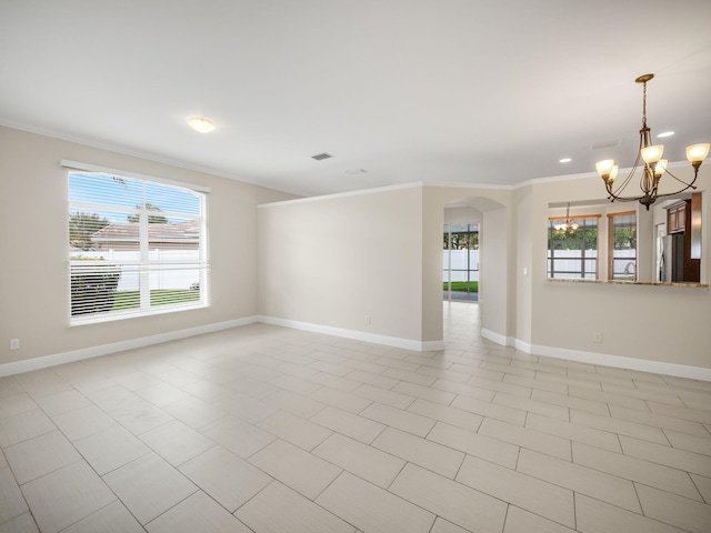 tiled empty room featuring crown molding and a chandelier